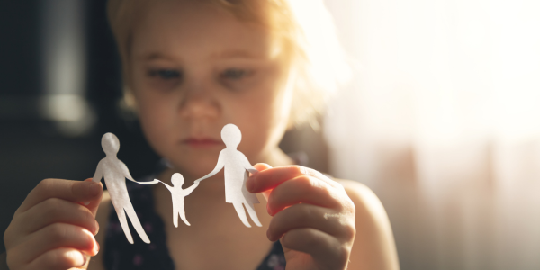 Lauth Investigations International | The Ins and Outs of Child Custody Investigations sad child holding paper silhouette of a family in her hands